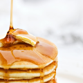 honey_being_drizzled_onto_buttered_pancakes